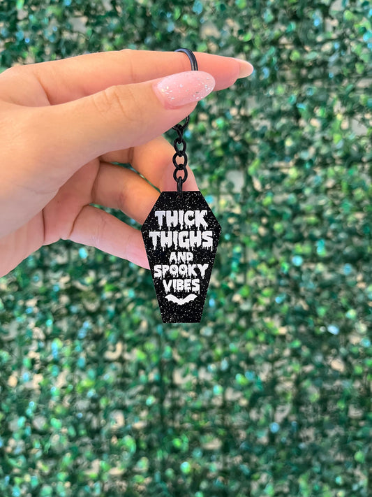 Black and white glittery ‘thick thighs and spooky vibes’ Halloween keyring keychain car keys.