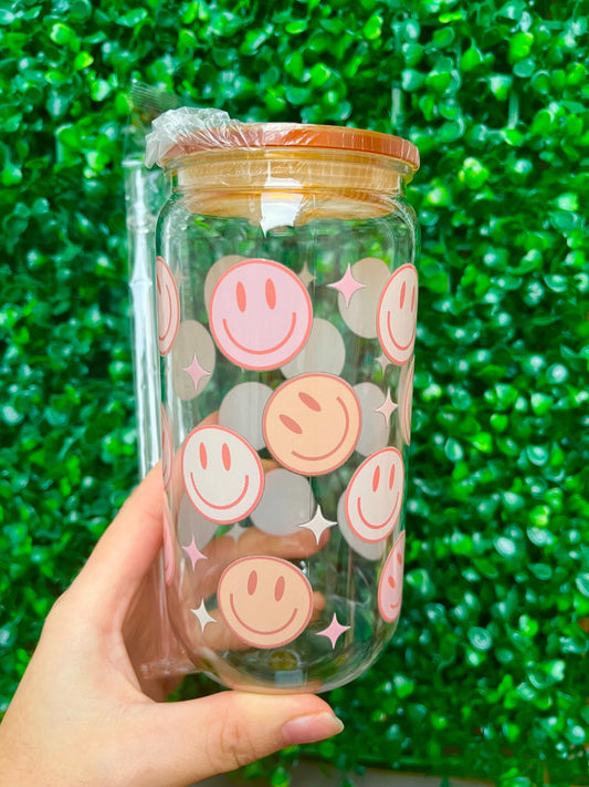 Pastel orange and pink smiley face 16oz plastic beer can tumbler cup with coloured lid and reusable plastic straw.